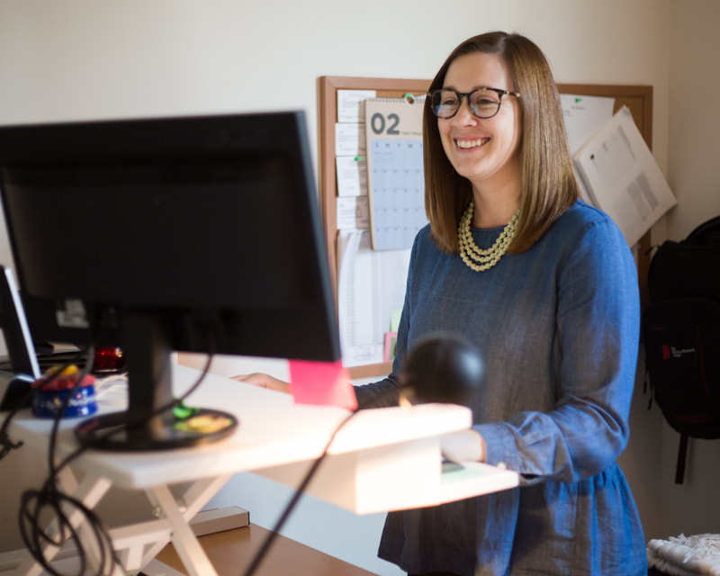 Woman Working at her Stand-Up Desk